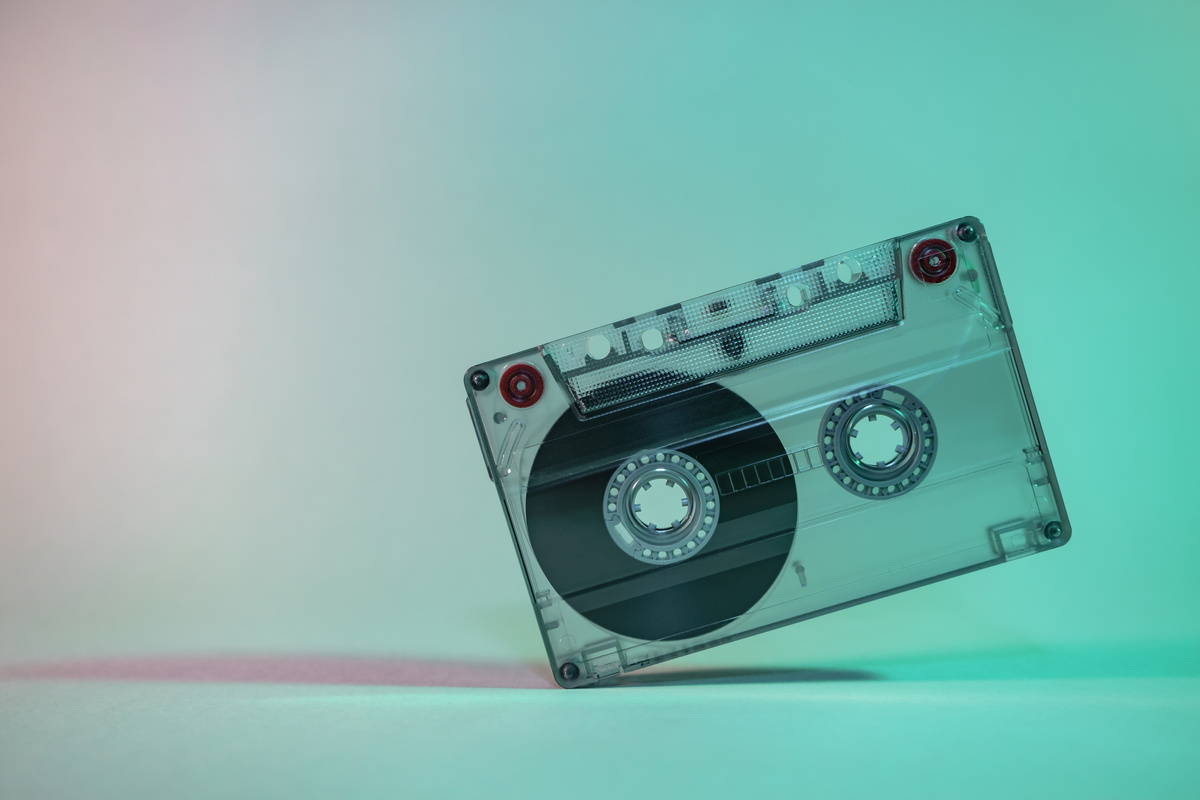Beautiful Audio cassette tape in neon  light.Minimalism retro style concept. 80s. Background pattern for design.